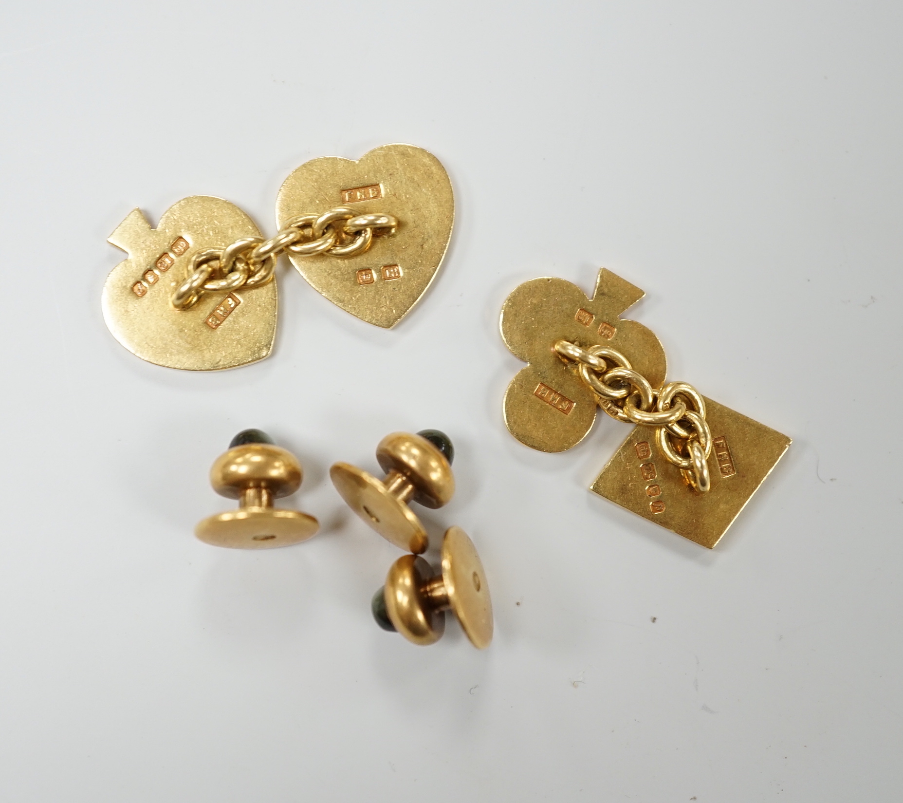 A pair of early 1970's 18ct gold novelty playing card suite cufflinks, 16 grams, together with three yellow metal and cat's eye chrysoberyl set dress studs.